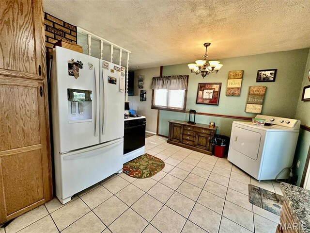 116 Charlene St, East Alton, IL 62024 - kitchen with white appliances, washer / dryer, a chandelier, light tile patterned flooring, and a textured ceiling