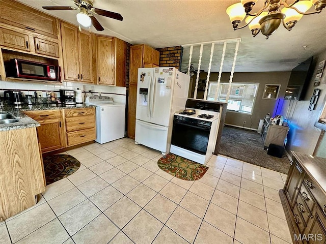 116 Charlene St, East Alton, IL 62024 - kitchen featuring washer / clothes dryer, gas range, white refrigerator with ice dispenser, light tile patterned floors, and a ceiling fan