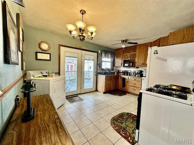 116 Charlene St, East Alton, IL 62024 - kitchen featuring washer / clothes dryer, white appliances, brown cabinetry, a chandelier, and a textured ceiling