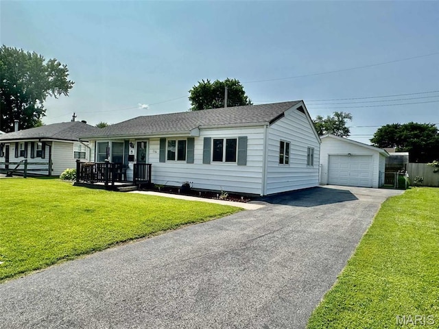 116 Charlene St, East Alton, IL 62024 - single story home with a detached garage, an outbuilding, a front yard, covered porch, and roof with shingles