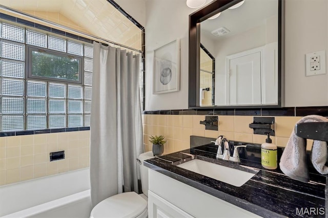 657 Lilac Ave, Webster Groves, MO 63119 - bathroom featuring vanity, shower / tub combo with curtain, and tile walls