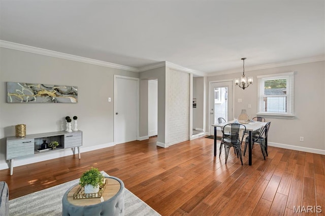657 Lilac Ave, Webster Groves, MO 63119 - dining area featuring a chandelier, ornamental molding, and wood finished floors