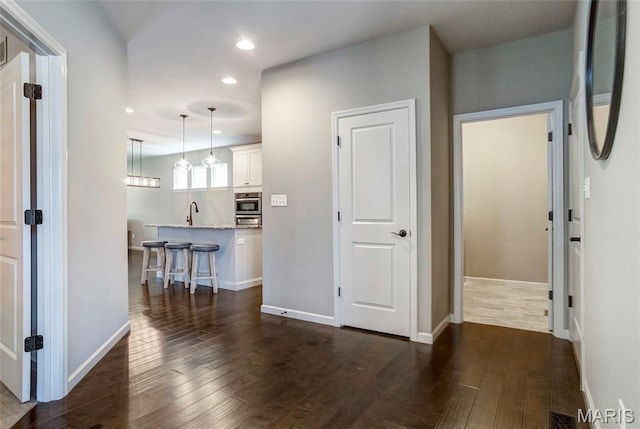 2216 Cournier St, Saint Charles, MO 63301 - hallway featuring dark wood-style floors and recessed lighting