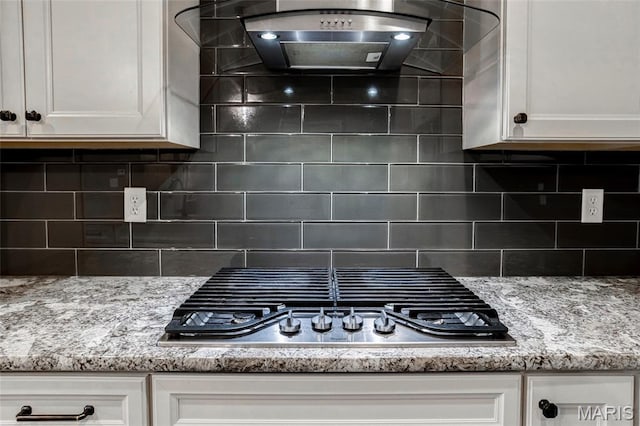 2216 Cournier St, Saint Charles, MO 63301 - kitchen view of stainless steel gas cooktop, custom exhaust hood, and white cabinets