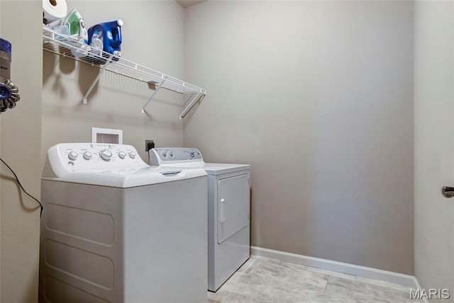 2216 Cournier St, Saint Charles, MO 63301 - laundry area featuring washing machine and clothes dryer and baseboards