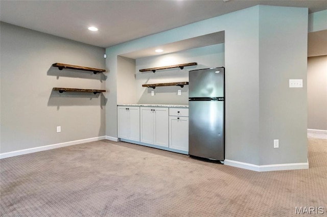 2216 Cournier St, Saint Charles, MO 63301 - kitchen with freestanding refrigerator, open shelves, light carpet, white cabinetry, and recessed lighting