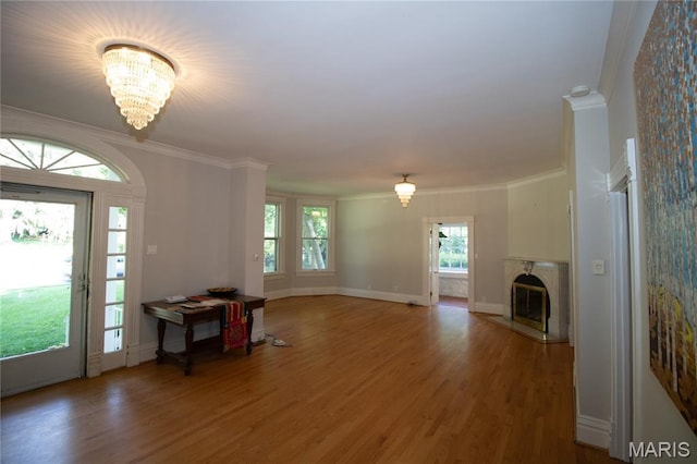 37 Joy Ave, Webster Groves, MO 63119 - foyer featuring wood finished floors, a chandelier, a glass covered fireplace, and ornamental molding