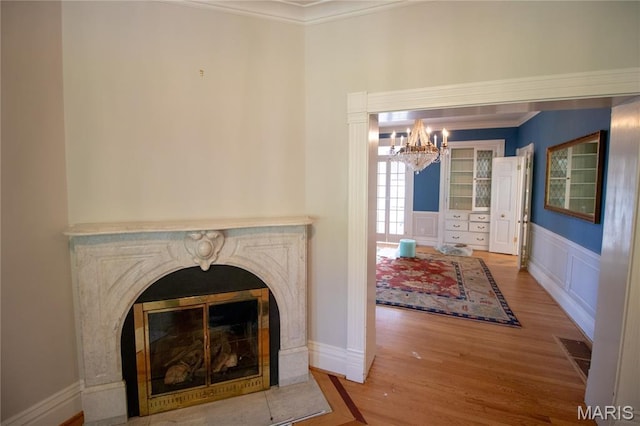 37 Joy Ave, Webster Groves, MO 63119 - living area featuring a chandelier, ornamental molding, wood finished floors, and wainscoting