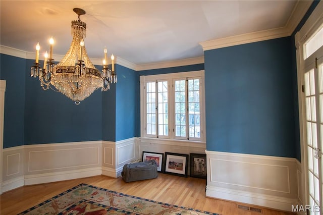 37 Joy Ave, Webster Groves, MO 63119 - spare room featuring a chandelier, wainscoting, wood finished floors, and crown molding