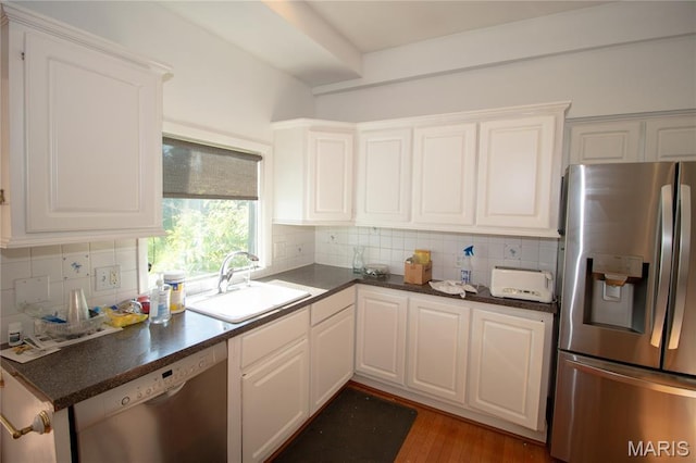37 Joy Ave, Webster Groves, MO 63119 - kitchen featuring stainless steel appliances, dark countertops, tasteful backsplash, and white cabinetry