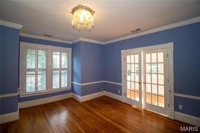 37 Joy Ave, Webster Groves, MO 63119 - spare room featuring wood finished floors, a chandelier, crown molding, and french doors