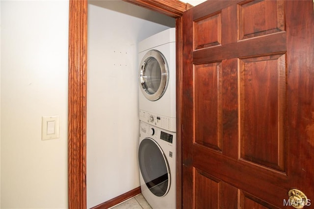 37 Joy Ave, Webster Groves, MO 63119 - washroom with stacked washer / dryer and light tile patterned floors