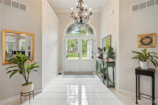 17 Eagles Way Ln, Lake St Louis, MO 63367 - entrance foyer with a chandelier, a towering ceiling, crown molding, and light tile patterned flooring