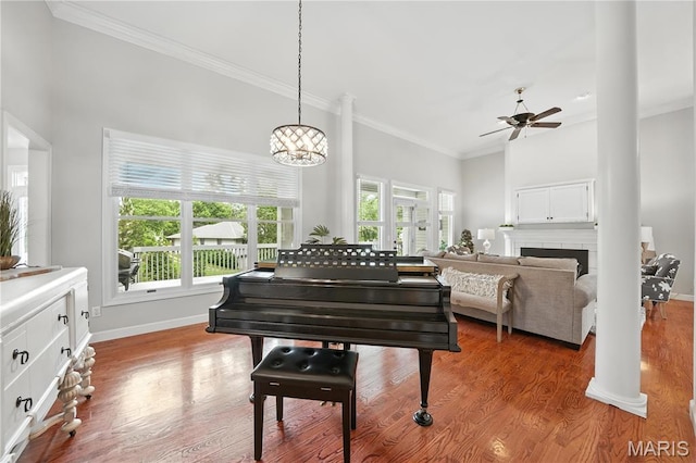 17 Eagles Way Ln, Lake St Louis, MO 63367 - living area featuring a ceiling fan, ornamental molding, a tile fireplace, light wood-style floors, and a chandelier