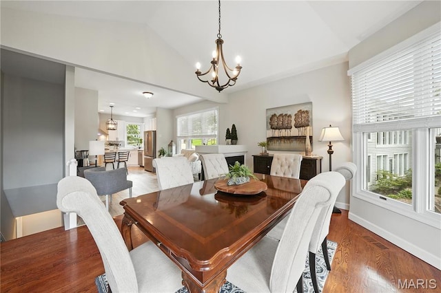 17 Eagles Way Ln, Lake St Louis, MO 63367 - dining space featuring a chandelier, vaulted ceiling, and light wood-type flooring