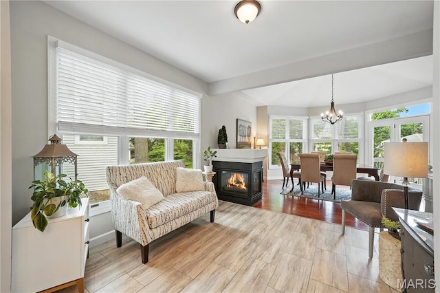 17 Eagles Way Ln, Lake St Louis, MO 63367 - living room with a chandelier, light wood finished floors, and a multi sided fireplace