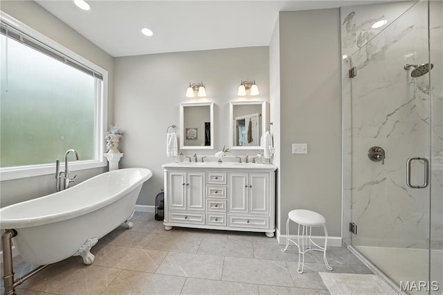 17 Eagles Way Ln, Lake St Louis, MO 63367 - bathroom featuring a marble finish shower, a freestanding bath, double vanity, and recessed lighting