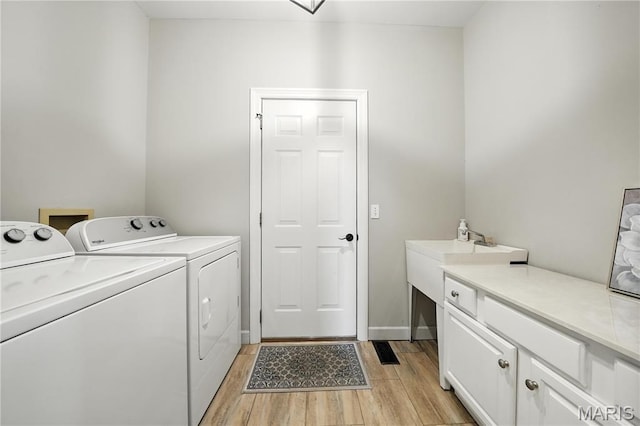 17 Eagles Way Ln, Lake St Louis, MO 63367 - laundry room with separate washer and dryer, light wood-style flooring, and cabinet space