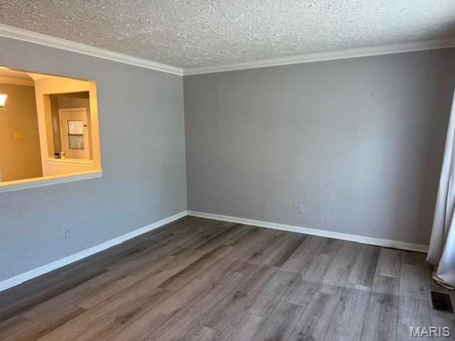 1496 Ville Rosa Ln, Hazelwood, MO 63042 - unfurnished room featuring wood finished floors, ornamental molding, and a textured ceiling