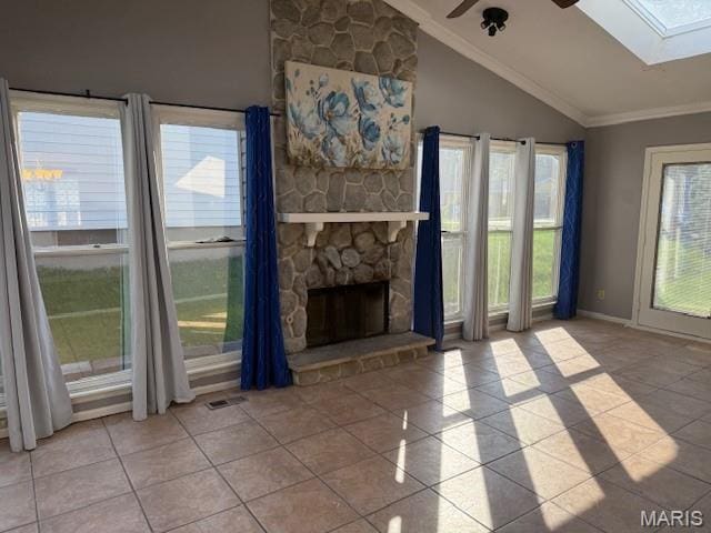 1496 Ville Rosa Ln, Hazelwood, MO 63042 - unfurnished living room featuring tile patterned floors, a skylight, lofted ceiling, ceiling fan, and ornamental molding