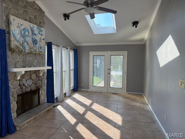 1496 Ville Rosa Ln, Hazelwood, MO 63042 - unfurnished living room with a skylight, ceiling fan, lofted ceiling, ornamental molding, and tile patterned flooring