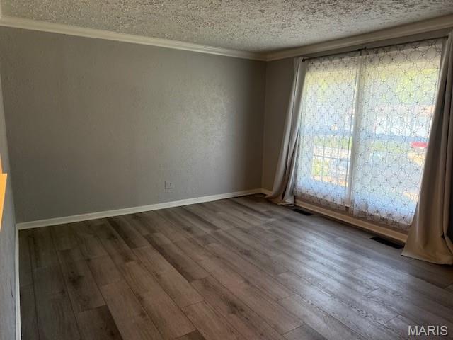 1496 Ville Rosa Ln, Hazelwood, MO 63042 - unfurnished room featuring a textured ceiling, wood finished floors, and crown molding