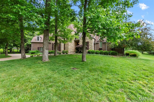 3046 Beaver Creek Cpe, Girardeau, MO 63701 - view of property hidden behind natural elements with a front lawn and brick siding