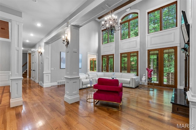3046 Beaver Creek Cpe, Girardeau, MO 63701 - living room featuring ornate columns, stairs, wood finished floors, a chandelier, and recessed lighting