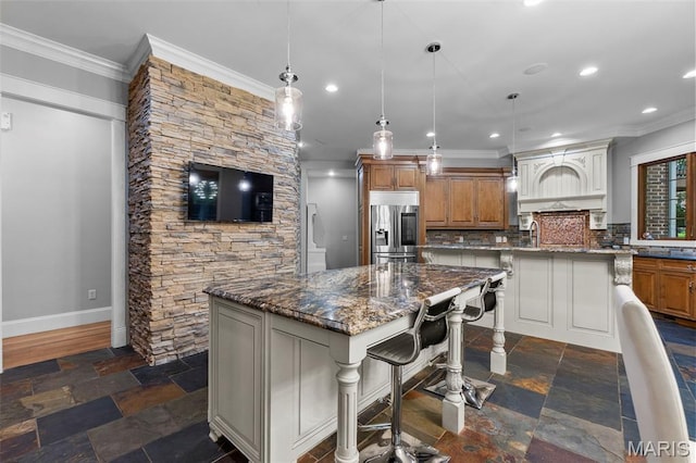 3046 Beaver Creek Cpe, Girardeau, MO 63701 - kitchen with stainless steel fridge with ice dispenser, a spacious island, ornamental molding, brown cabinetry, and recessed lighting