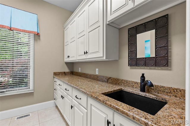 3046 Beaver Creek Cpe, Girardeau, MO 63701 - kitchen featuring light tile patterned flooring, white cabinetry, and light stone counters