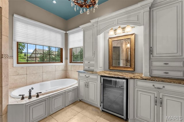 3046 Beaver Creek Cpe, Girardeau, MO 63701 - full bathroom featuring wine cooler, a bath, tile patterned floors, and a chandelier