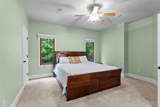 3046 Beaver Creek Cpe, Girardeau, MO 63701 - bedroom with light colored carpet, multiple windows, and ceiling fan