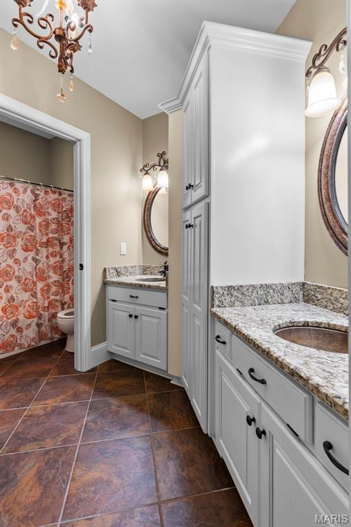 3046 Beaver Creek Cpe, Girardeau, MO 63701 - full bathroom with two vanities, tile patterned flooring, and a chandelier