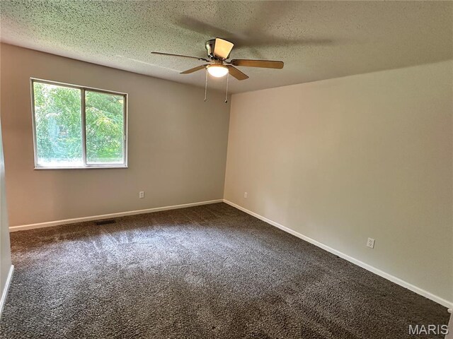 807 Corey Ct, Wentzville, MO 63385 - spare room with a ceiling fan, dark colored carpet, a textured ceiling, and baseboards