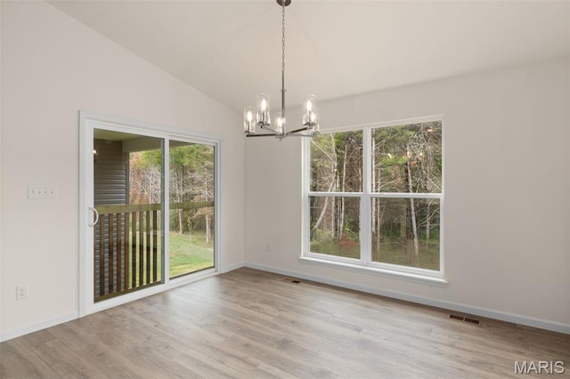 1720 Martingale Ln, Eureka, MO 63025 - unfurnished dining area with a chandelier, wood finished floors, baseboards, and vaulted ceiling