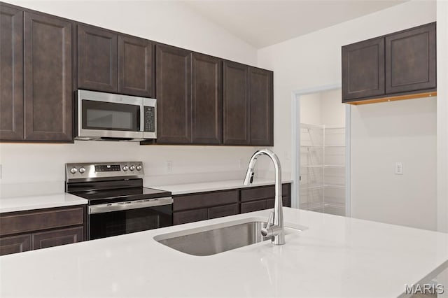1720 Martingale Ln, Eureka, MO 63025 - kitchen featuring stainless steel appliances, a sink, light countertops, and dark brown cabinetry