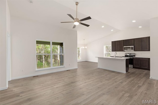 1720 Martingale Ln, Eureka, MO 63025 - kitchen featuring stainless steel appliances, open floor plan, vaulted ceiling, light countertops, and ceiling fan