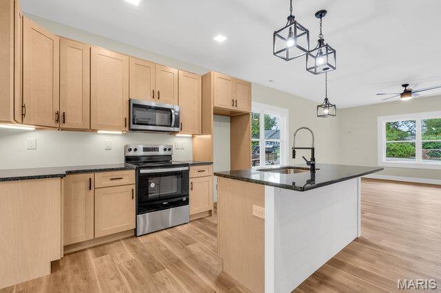 410 Roosevelt, Warrenton, MO 63383 - kitchen featuring appliances with stainless steel finishes, light brown cabinetry, light wood-style floors, pendant lighting, and recessed lighting