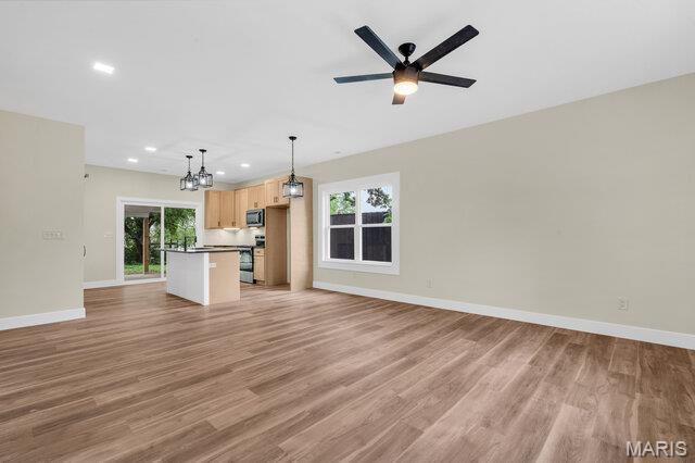 410 Roosevelt, Warrenton, MO 63383 - unfurnished living room featuring recessed lighting, plenty of natural light, a chandelier, light wood-type flooring, and ceiling fan