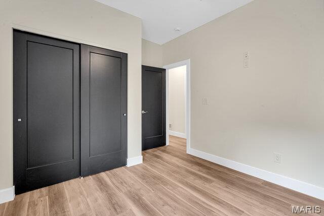 410 Roosevelt, Warrenton, MO 63383 - unfurnished bedroom with light wood-style floors and a closet
