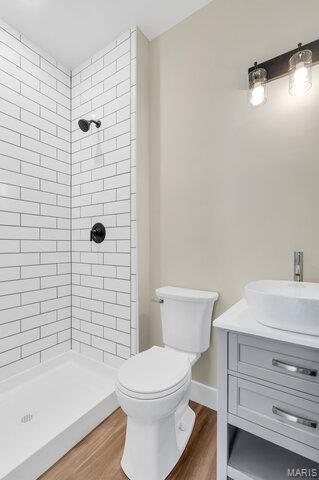 410 Roosevelt, Warrenton, MO 63383 - full bathroom featuring wood finished floors, tiled shower, and vanity