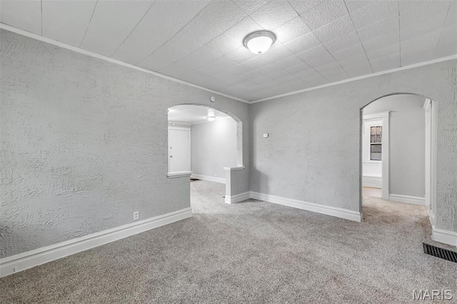 1323 Fairview Ave, University City, MO 63130 - carpeted spare room featuring arched walkways, crown molding, and a textured wall