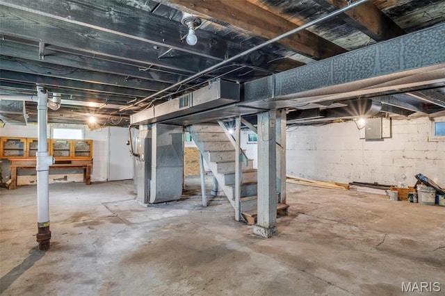 1323 Fairview Ave, University City, MO 63130 - below grade area featuring heating unit, stairway, and electric panel