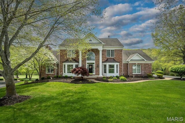 1417 Wheatfield Ln, Saint Albans, MO 63073 - greek revival house with a front lawn and brick siding