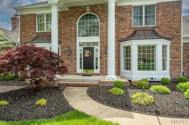 1417 Wheatfield Ln, Saint Albans, MO 63073 - doorway to property with brick siding, a standing seam roof, a metal roof, and roof with shingles