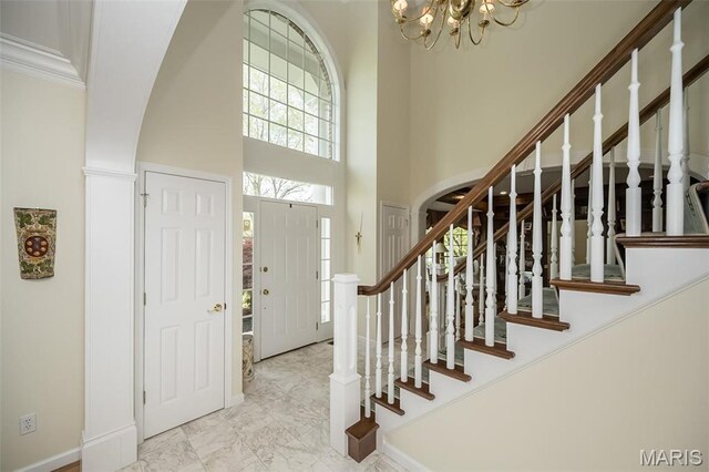 1417 Wheatfield Ln, Saint Albans, MO 63073 - entrance foyer featuring a towering ceiling, a chandelier, stairway, and arched walkways