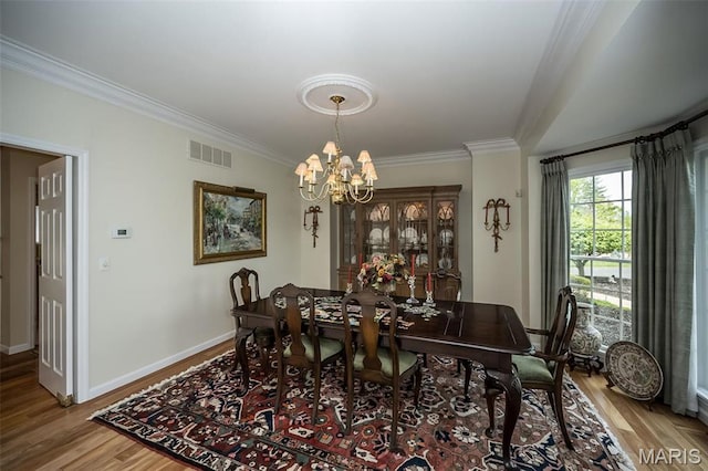 1417 Wheatfield Ln, Saint Albans, MO 63073 - dining room with crown molding, wood finished floors, and a chandelier