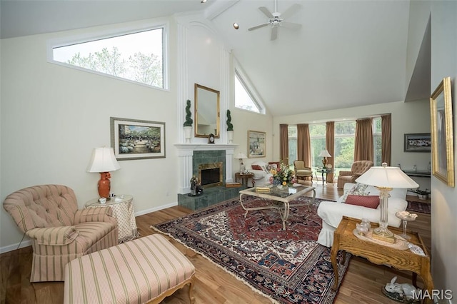 1417 Wheatfield Ln, Saint Albans, MO 63073 - living area with high vaulted ceiling, a ceiling fan, a tiled fireplace, and wood finished floors
