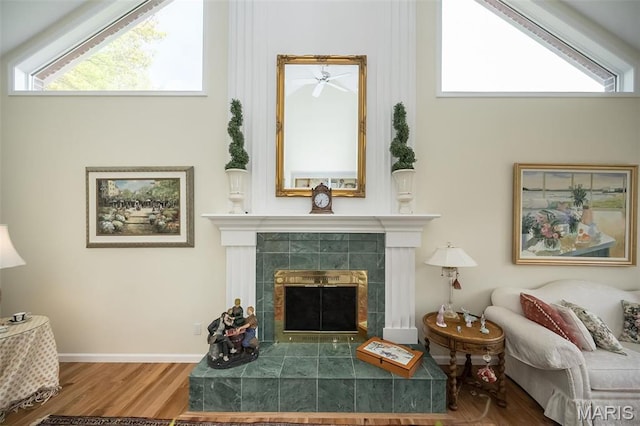 1417 Wheatfield Ln, Saint Albans, MO 63073 - living area featuring a fireplace, wood finished floors, healthy amount of natural light, and a ceiling fan