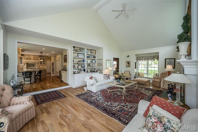 1417 Wheatfield Ln, Saint Albans, MO 63073 - living room featuring high vaulted ceiling, light wood-style floors, a ceiling fan, and beam ceiling